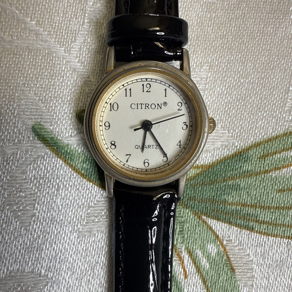 Citron Vintage Women’s Watch, White dial and gold casing. Black leather band.